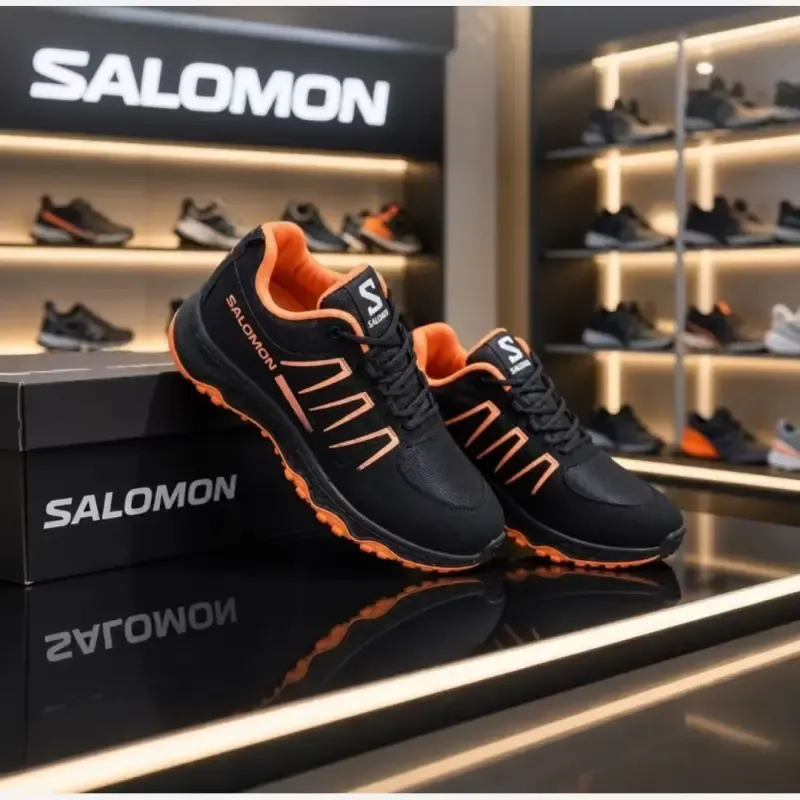 کتانی مردانه سالامون رنگ مشکی نارنجی مناسب پیاده روی و باشگاه